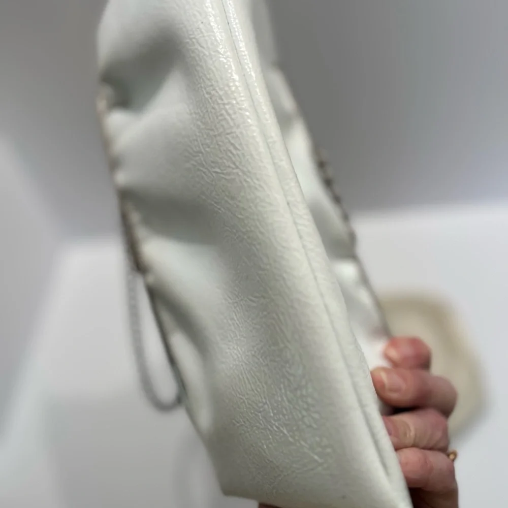 Vintage pair of white leather clutches, one is 70’s with great blk/white lining